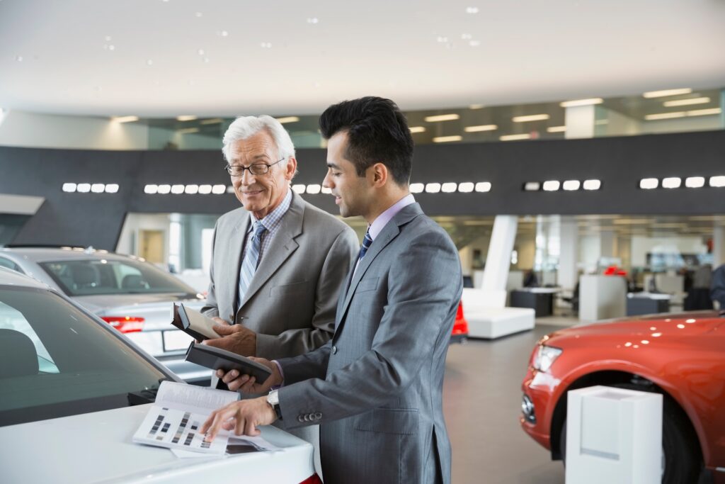 salesman and man with brochure in car showroom 2025 10 15 04 46 59 utc