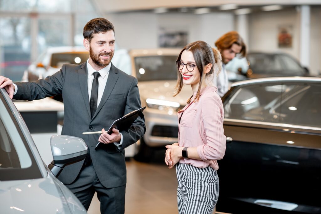 salesperson with client in the car showroom 2025 03 17 04 06 07 utc